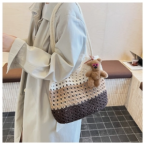 Close-up of woven tote bag texture with brown teddy bear charm and heart glasses