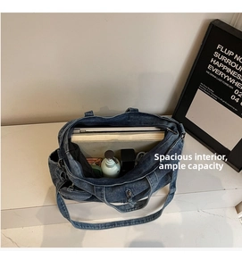 Top view of large denim tote bag showing spacious interior with laptop and books
