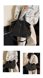 Detailed views of a black washed denim tote bag with side coin purse and zipper accent