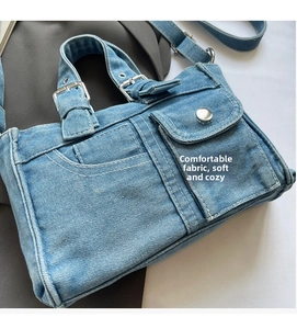 Close-up of retro denim handbag with buckle details and decorative front flap pocket