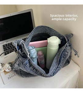 Spacious interior of washed denim tote bag fitting a 13-inch laptop and daily essentials
