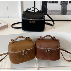 Three retro boxy bags in lychee leather and suede textures with metallic locks