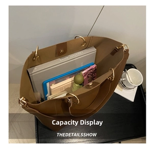 Brown tote bag interior showing capacity for tablet, books, wallet and accessories