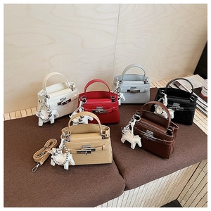 Detail of six textured crocodile pattern handbags with silver hardware and horse charms