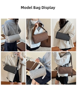 Polka dot cylinder pillow bag in white, brown, and black colors with broad strap detail