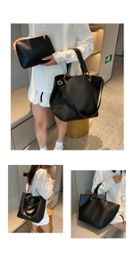 Detail of black leather tote bag set with golden metal ring handles and removable strap