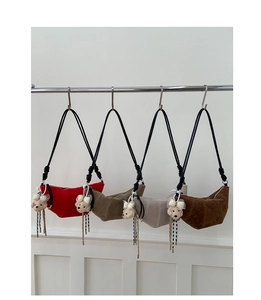 Row of four colorful frosted suede crescent bags with cute bear plush charms