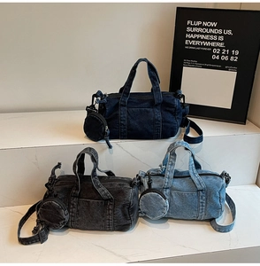 Close-up of three colors of washed denim Boston bags with detachable round coin purses