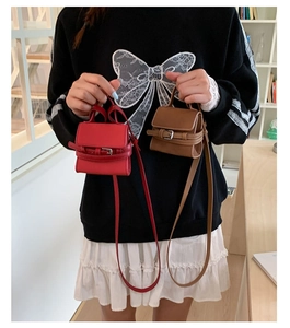 Red and brown mini leather crossbody bags with flap closure and buckle detail