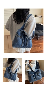 Detail of vintage blue denim tote bag featuring functional zippers and wide shoulder strap