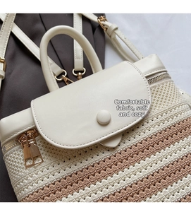 Detail of woven straw backpack with white leather flap and golden zipper hardware
