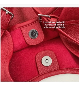 Detail of red pebbled leather tote showing the silver magnetic closure and soft lining