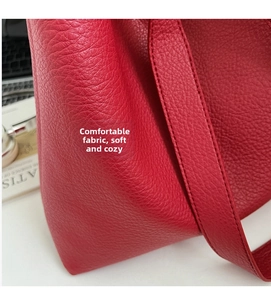 Detail of red lychee grain leather tote bag showing high-quality texture and strap
