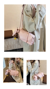 Close-up of pink leather tote bag with lychee texture and colorful bag charms