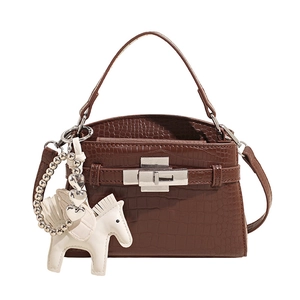 Brown crocodile embossed handbag with silver clasp and white pegasus charm ornament