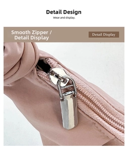 Detailed close-up of the smooth silver metal zipper on a pink matte leather crossbody bag