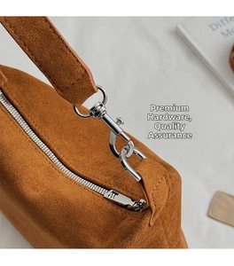 Close-up detail of high-quality silver metal hardware on a brown suede vintage hobo bag