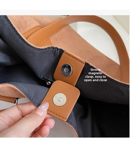 Detail view of strong magnetic closure on brown matte tote bag with durable lining