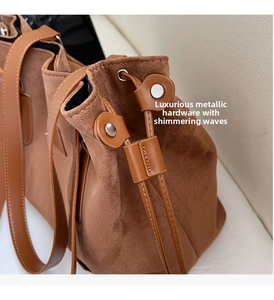 Detailed macro view of smooth silver metal hardware and premium brown suede material