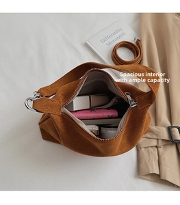 Interior capacity detail view of a vintage brown suede dumpling shoulder bag with items