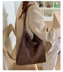 Vue détaillée du sac cabas en daim marron foncé avec coutures décoratives signatures