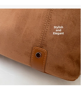 Detail view of brown matte suede texture with precision stitching and metal rivet buckle