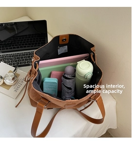 Interior view of large brown suede tote bag showing capacity for laptop and daily essentials