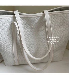 Detail shot of white woven tote bag showing durable texture and slim leather handles