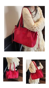 Detail of red oversized suede tote bag with drawstring, silver buckles, and rivet studs