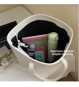Large capacity white woven tote bag interior showing laptop and daily essentials storage