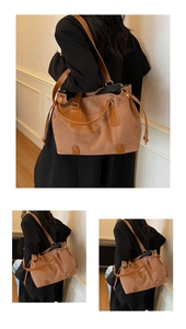 Close-up of vintage brown suede tote bag with leather straps and drawstring detail
