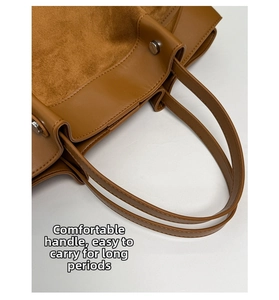 Detail view of brown tote bag with suede contrast stitching and silver metal rivets