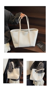 Detail of white woven texture tote bag featuring a large capacity and dual shoulder straps