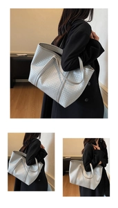 Close-up of matte silver woven tote bag showing detailed texture and large capacity