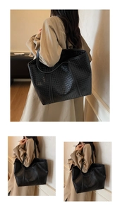 Detail of black woven leather tote bag with large capacity and reinforced shoulder straps