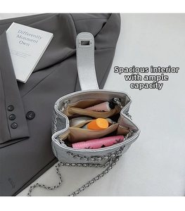 Interior view of silver chain bag showing multi-compartment leather layout and storage