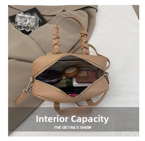 Interior view of small camel pebble leather handbag showing daily essentials and zip pocket