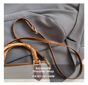 Detail view of the vintage woven bucket bag featuring a natural bamboo handle and strap