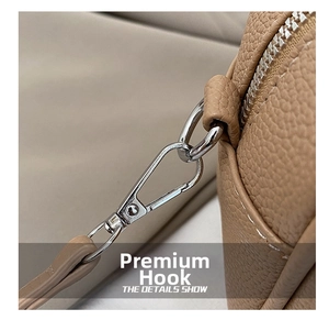 Detail shot of silver lobster clasp and leather strap on a brown Boston bowling bag