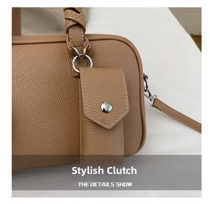 Detailed view of brown lychee leather handbag with woven handle and matching mini pouch