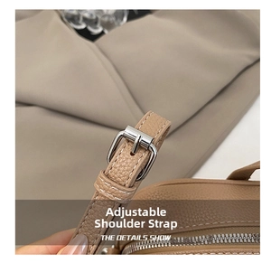 Detail of adjustable leather strap with silver buckle on brown Boston bowling bag