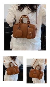 Dettaglio borsa Boston marrone in pelle martellata con manici intrecciati e accessori