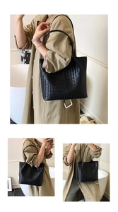 Détail du sac cabas en cuir tressé noir avec grande capacité et poignées fines