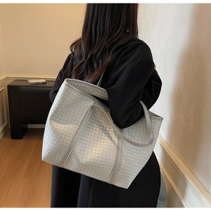 Detailed view of silver woven tote bag showing large capacity and checkered texture