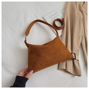 Detailed view of brown suede underarm bag showcasing premium texture and stylish daily design.