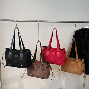 Matte retro shoulder bags in black, brown, and red colors shown on hangers
