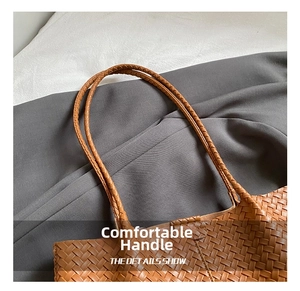 Gros plan sur les poignées tissées marron et la texture d'un grand sac à main