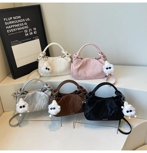 Detail of five mini textured cloud bags with knot handles and plush monster charms