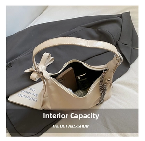 Internal view of the cream leather dumpling bag showing spacious storage for essentials
