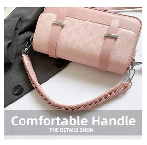 Detail of pink woven leather bag showing textured pattern and braided handle with silver clips